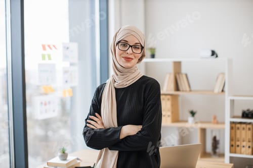 Preview: Muslim entrepreneur posing with arms crossed in office