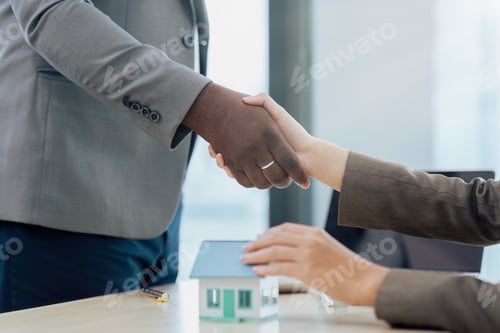Preview: Real estate broker agent manager shaking hands with a client after successful agreement in the