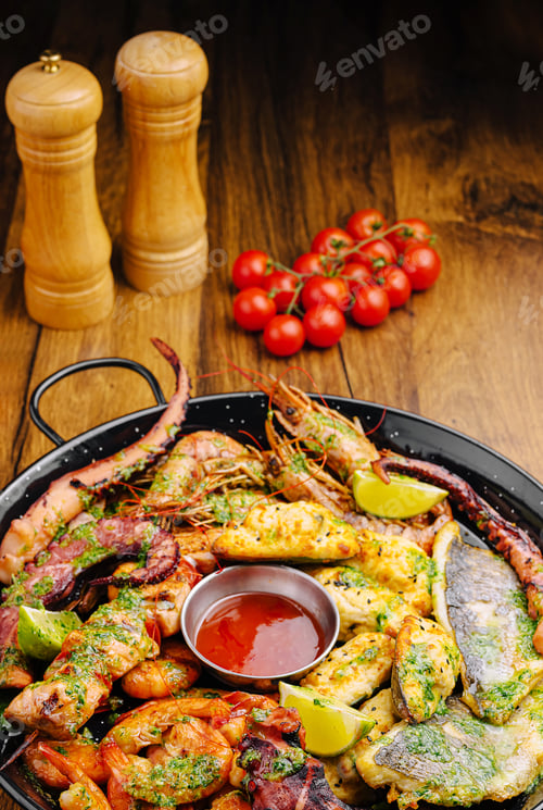 Preview: Seafood platter featuring grilled shrimp, fish, and vegetables on wooden table