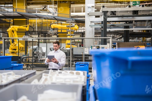 Preview: Man using tablet in factory shop floor