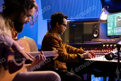 Preview: Artist playing a song on electro acoustic guitar in professional studio