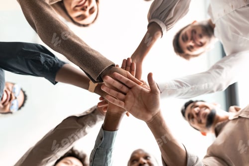 Preview: Diverse business people putting their hands together in cirle