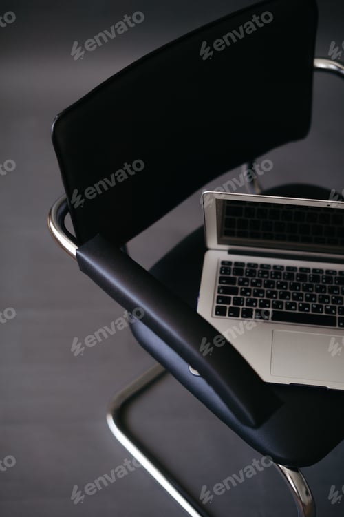 Preview: Laptop on the chair, dark background