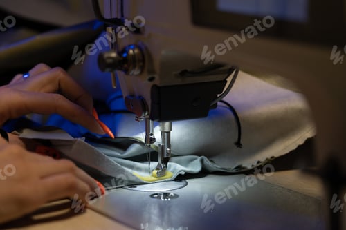 Preview: Seamstress work on sewing machine, closeup. Woman fashion designer create new clothes collection