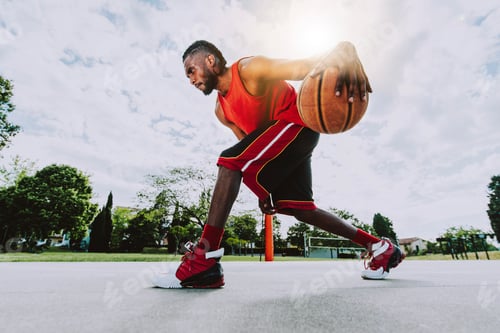 Preview: Basketball street player dribbling with ball on the court