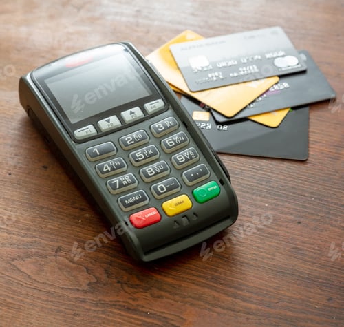 Preview: Payment machine, POS terminal and credit cards on wooden desk