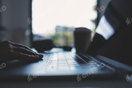 Preview: Closeup image of hand working and touching on laptop touchpad on the table