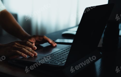 Preview: working late on laptop at home