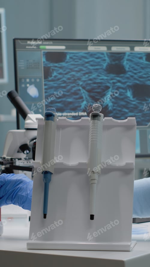 Preview: Scientist woman sitting in laboratory with chemical technology