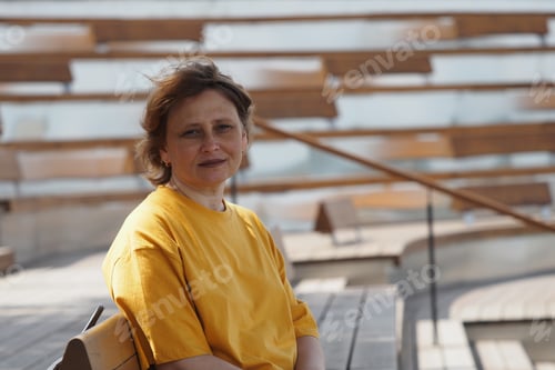 Preview: female portrait. girl of European appearance in summer in a yellow T-shirt in the park.