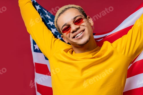 Preview: Happy man with national USA flag on red background. American patriot 4th of July