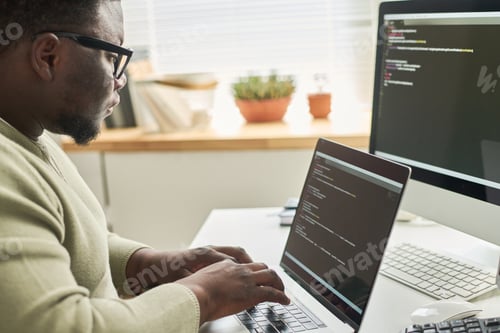 Preview: Programmer typing data code on laptop
