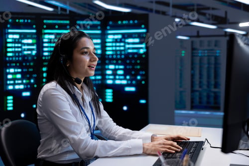 Preview: Smiling engineer in data center providing support for companies