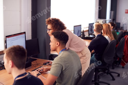Preview: Group Of College Students With Tutor Studying Computer Design Sitting At Monitors In Classroom