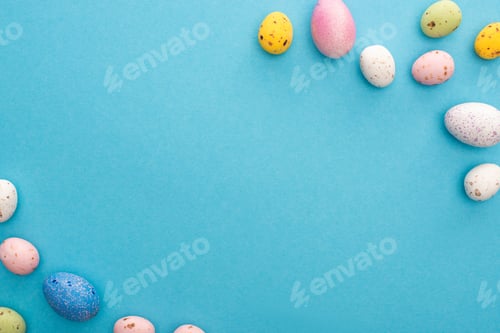 Preview: Top view of colorful painted chicken and quail eggs on blue background