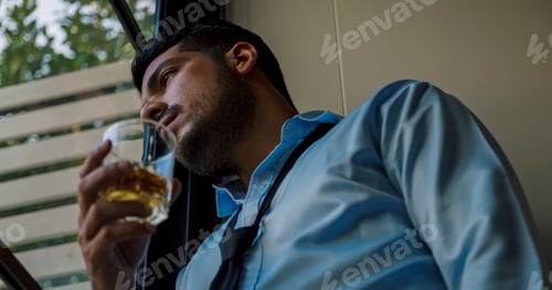 Preview: A businessman drinking alcohol to relieve depressed and stressed with problems in his life.