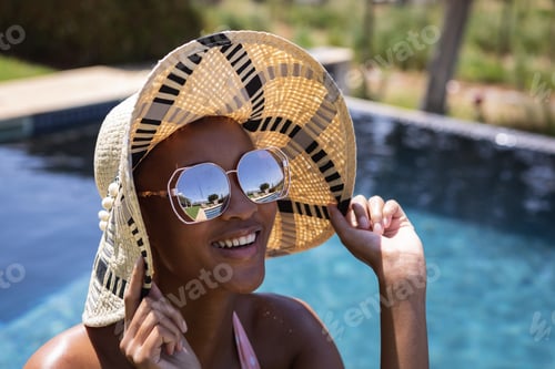 Preview: Woman wearing hat and sunglasses