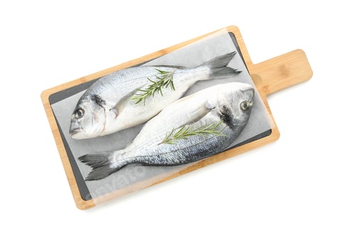 Preview: Cutting board with Dorado fishes and rosemary isolated on white background
