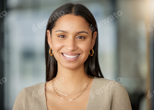 Preview: Portrait of a confident young businesswoman working in a modern office