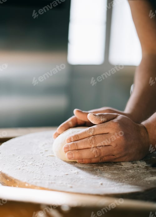 Preview: Man kneading and baking homemade pizza dough in the kitchen.