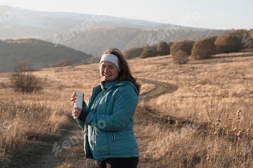 Preview: Woman Smiling, Drinking Coffee in Mountain Field