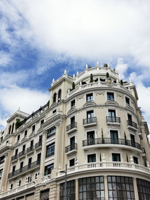Preview: Vertical shot of a beautiful rounded white building in Madrid, Spain