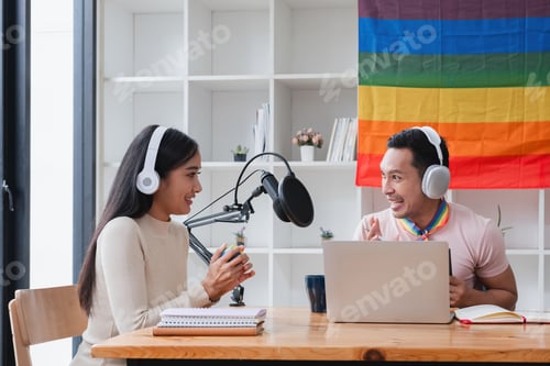 Preview: A young gay man and his girlfriend use a laptop and microphone to stream podcast audio at a studio