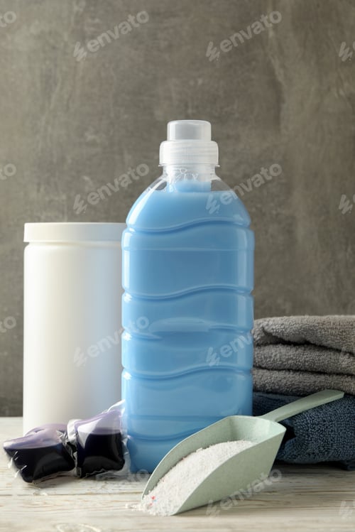 Preview: Laundry accessories on white wooden table against gray background