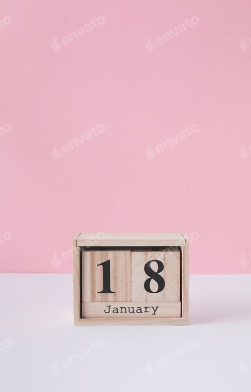 Preview: close up view of wooden calendar isolated on pink