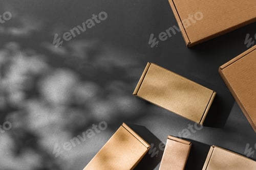 Preview: Various sizes of brown cardboard boxes arranged on a black surface with soft lighting effects during