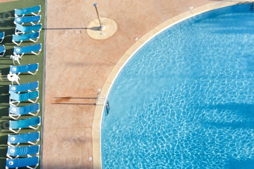 Preview: Sun loungers by a pool, taken from above.