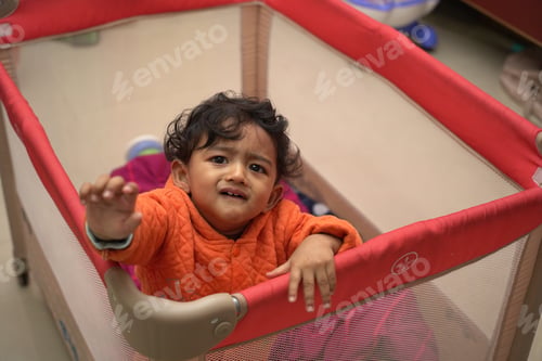 Preview: Boy toddler crying in a playpen