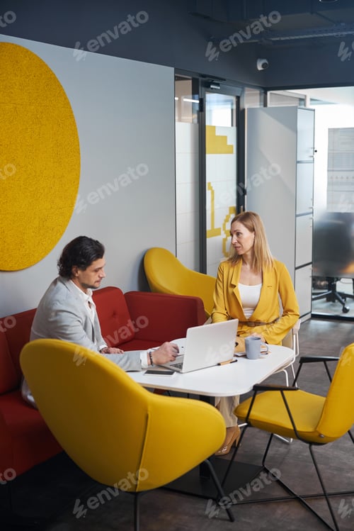 Preview: Concentrated male person talking to his colleague