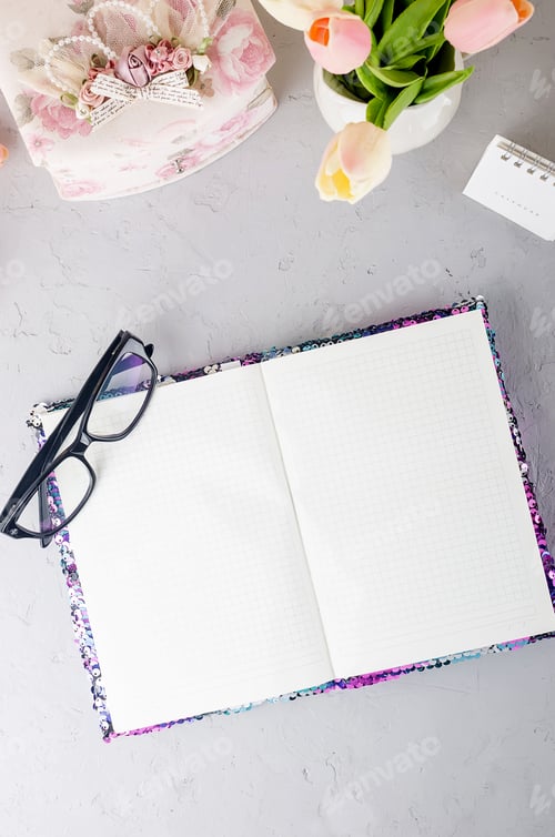 Preview: workplace with empty notebook,pen, tulips, eyeglass, work from home or blogging concept
