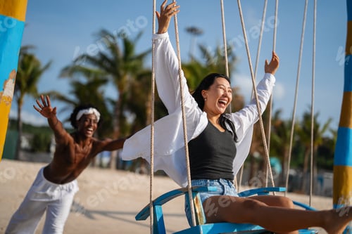 Preview: Interracial couple enjoying the freedom of summer, laughing and playing on a tropical beach