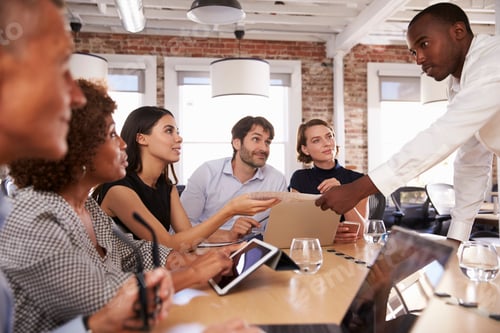 Preview: Businesspeople Meeting Around Table In Modern Office