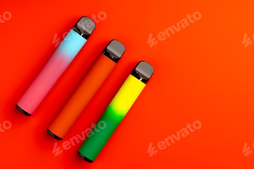 Preview: Disposable electronic cigarettes on red background close up