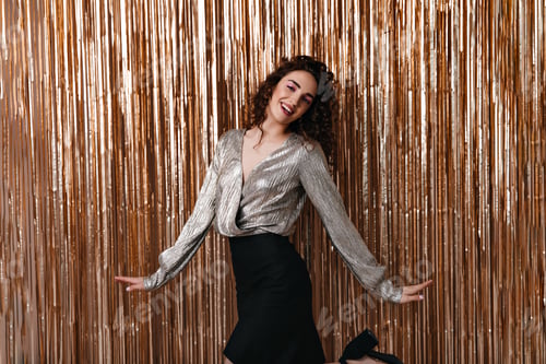 Preview: Lady in shiny blouse having fun on gold background