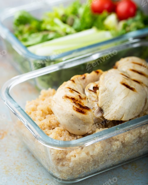 Preview: Healthy meal prep containers with quinoa, chicken breast and green salad overhead shot.