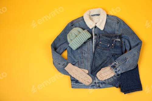 Preview: Concept of winter clothes on yellow background