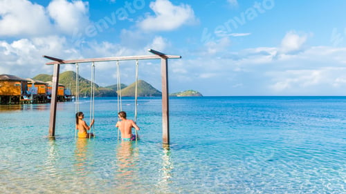 Preview: Couple in a swing on the beach of the tropical Island Saint Lucia or St Lucia Caribbean