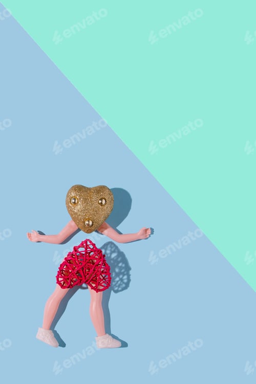 Preview: Vertical shot of a heart-shaped doll posing on a multicolor pastel background