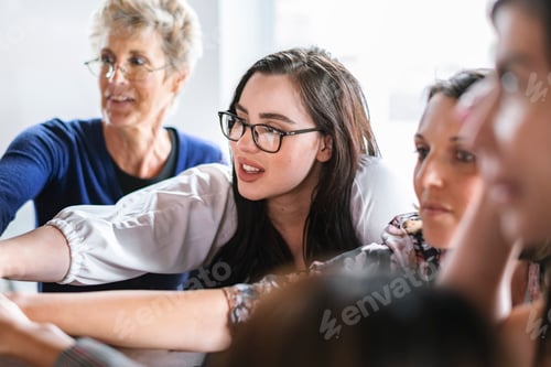 Preview: Businesswomen putting their hands together