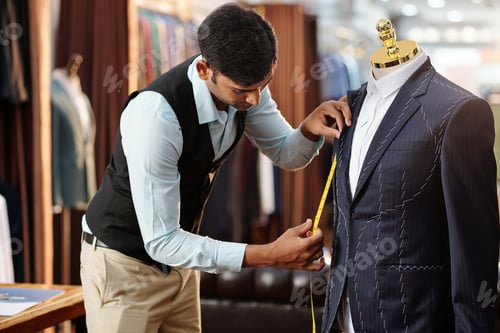 Preview: Tailor Measuring Suit with Tape in Clothing Store