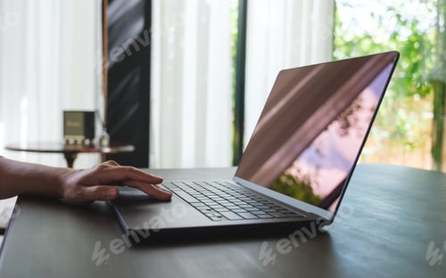 Preview: Closeup image of a woman hand working and touching on laptop computer touchpad