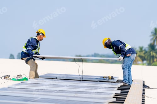 Preview: workers installing solar panels, for efficient energy on rooftop