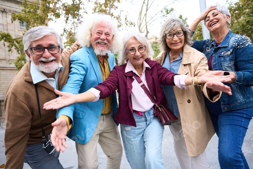Preview: Happy senior friends smiling and gesturing outdoors