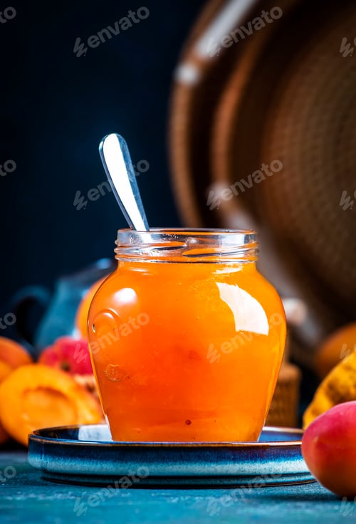 Preview: Sweet Apricot jam or confiture in glass jar with metal spoon and fresh fruits