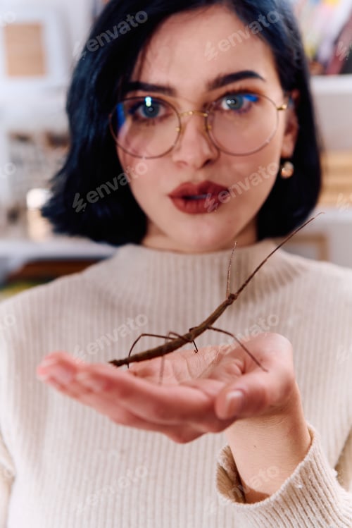 Preview: Young Woman Captured in a Beautiful Moment with Her Stick Insect (Medauroidea Extradentata)