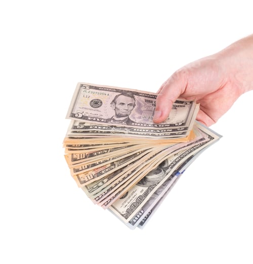 Preview: Hand holding dollar banknotes.